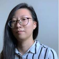 DataX artist Hye Min Cho in blue striped shirt wearing glasses