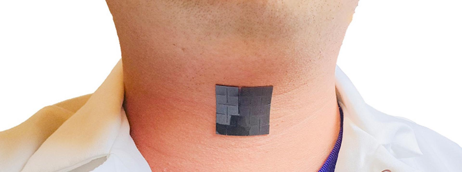 Photo of an assisted technology placed on someones throat area
