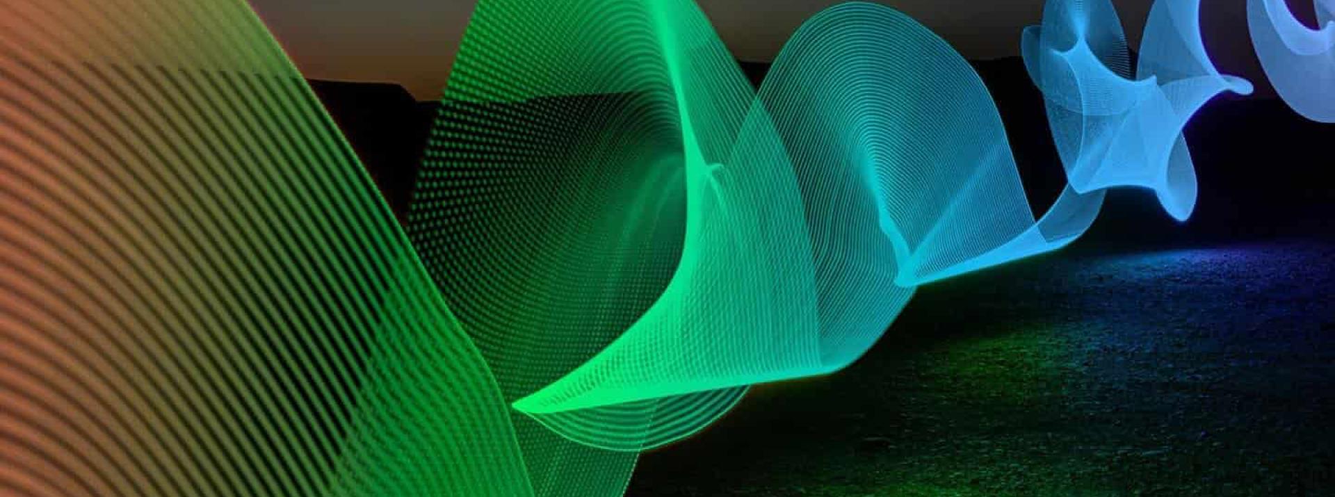 Green and blue color waves against a black background.