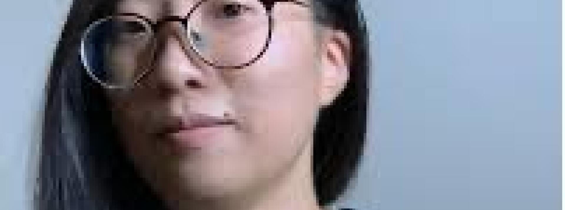 DataX artist Hye Min Cho in blue striped shirt wearing glasses