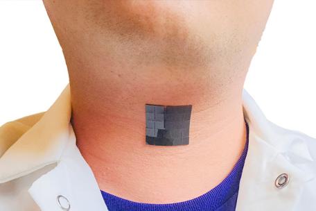 Photo of an assisted technology placed on someones throat area