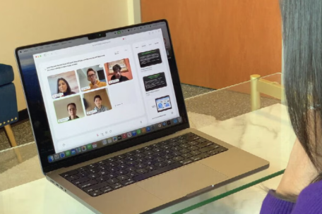 Student viewing a laptop to interact with an online class 