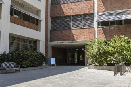 Brick building displaying entrance with sign above it saying Math & Sciences building.
