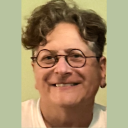 lisa denenmark, communications director wearing glasses, smiling