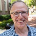 Chris Johanson in blue-checked shirt outside Murphy Hall.