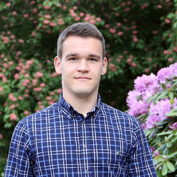 Drago Plecko, DataX affiliated faculty, wearing a plaid shirt in a garden.