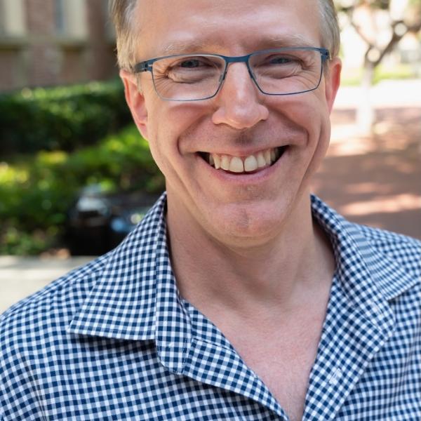 Chris Johanson in blue-checked shirt outside Murphy Hall.